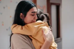 Mother hugging her daughter